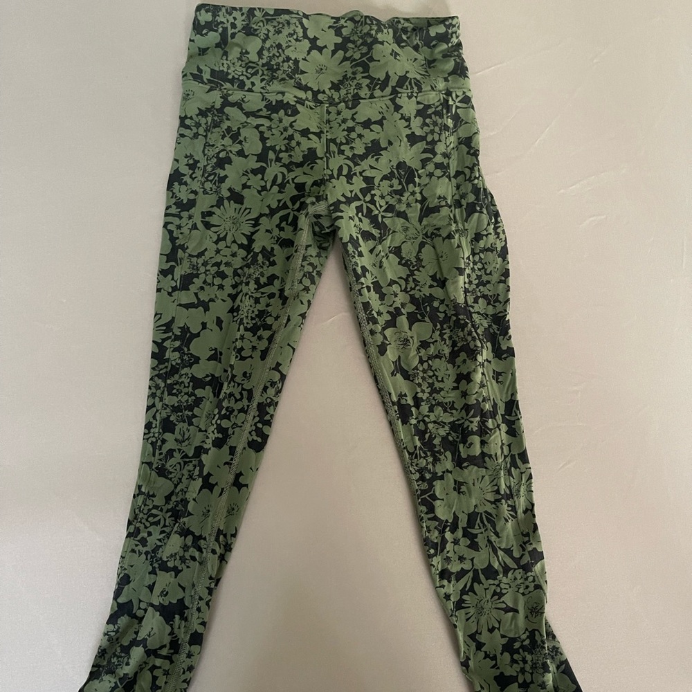 Lululemon green and black leggings with curved bottom hem